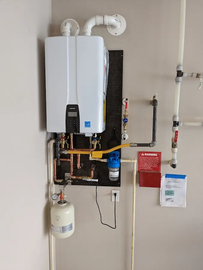 Professional plumber installing copper piping in a Soldotna home
